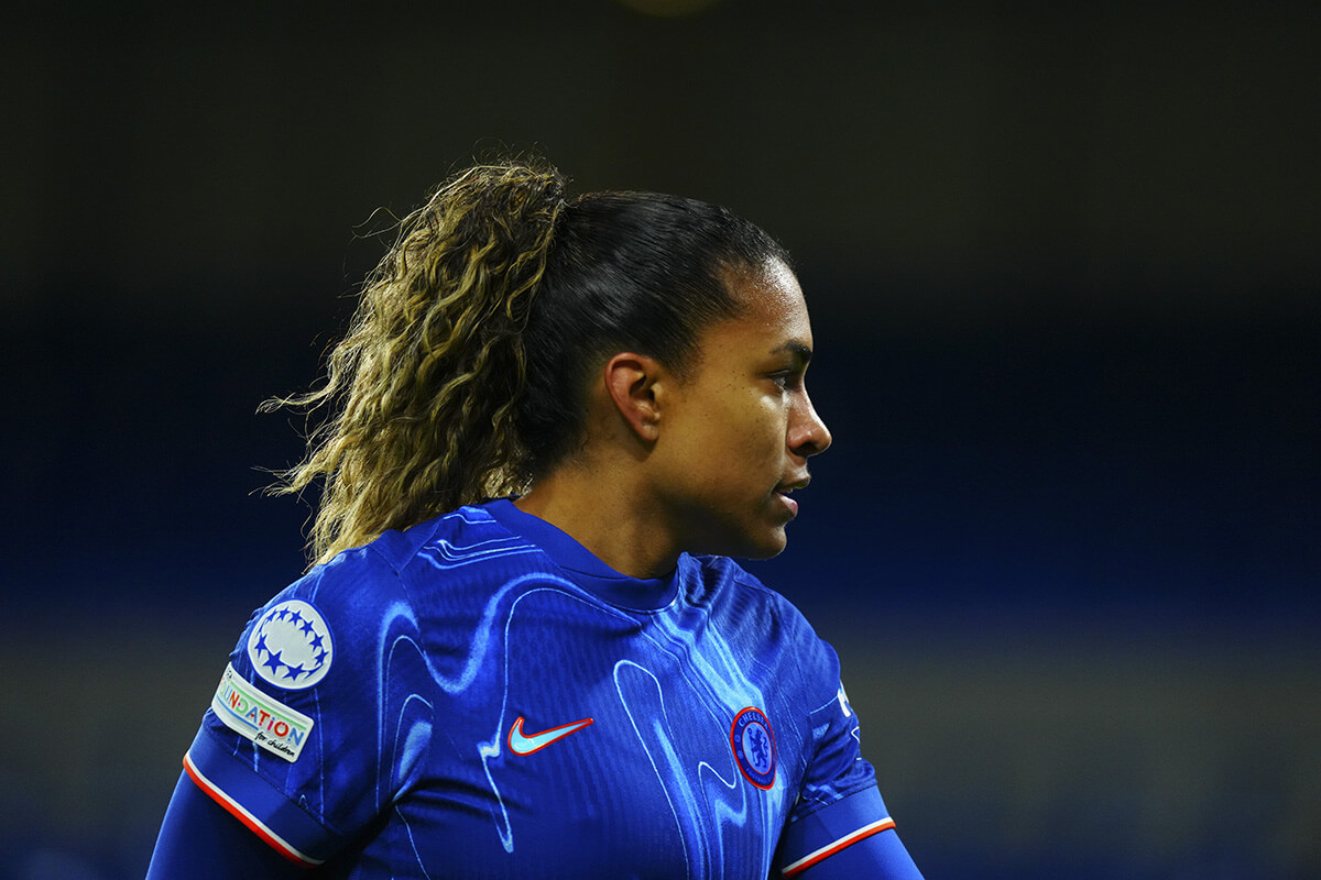 Image showing a Chelsea women's team player in action with a Womens UCL badge on her sleeve