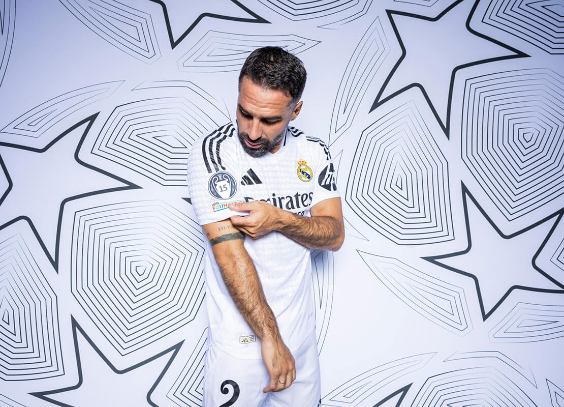 Image showing a Real Madrid player posing and holding his sleeve out to showcase the 15 times winner UCL badge